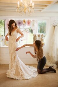 Bride in a lace wedding gown during a professional bridal fitting
