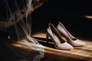 Bridal shoes beside a wedding veil styled for a final wedding day detail shot